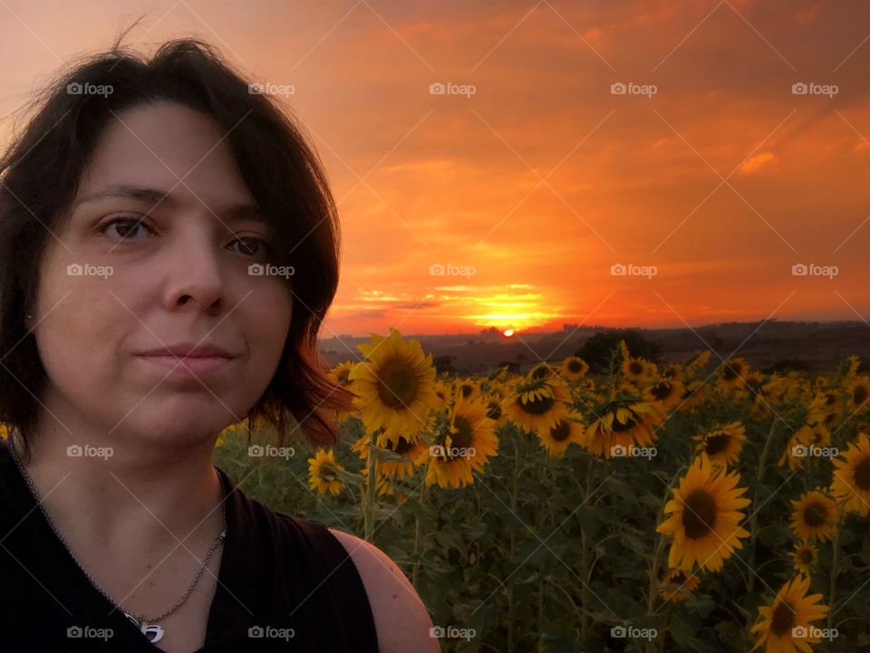 When the sunset is so beautiful and you want to be part of it. The colors created by the sun going down increases the magic in the sunflower field, and I cannot resist taking a selfie, and being involved in the magic.