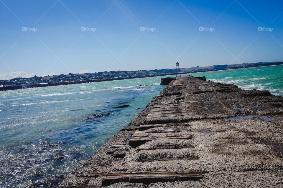 Beautiful blue-green water at the Oamaru Breakwater, New Zealand 