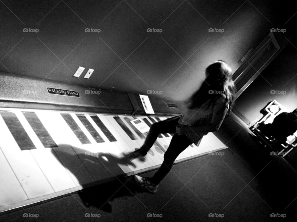 Girl playing walking piano. 9 year old girl playing walking piano