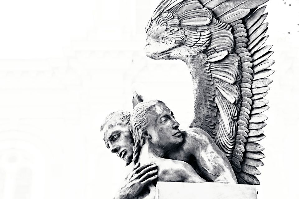 a statue of an Angel giving protection of a weary woman, architecture, statue, black and white, Outdoors,