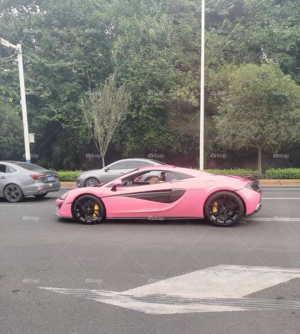 Barbie pink color car on the road