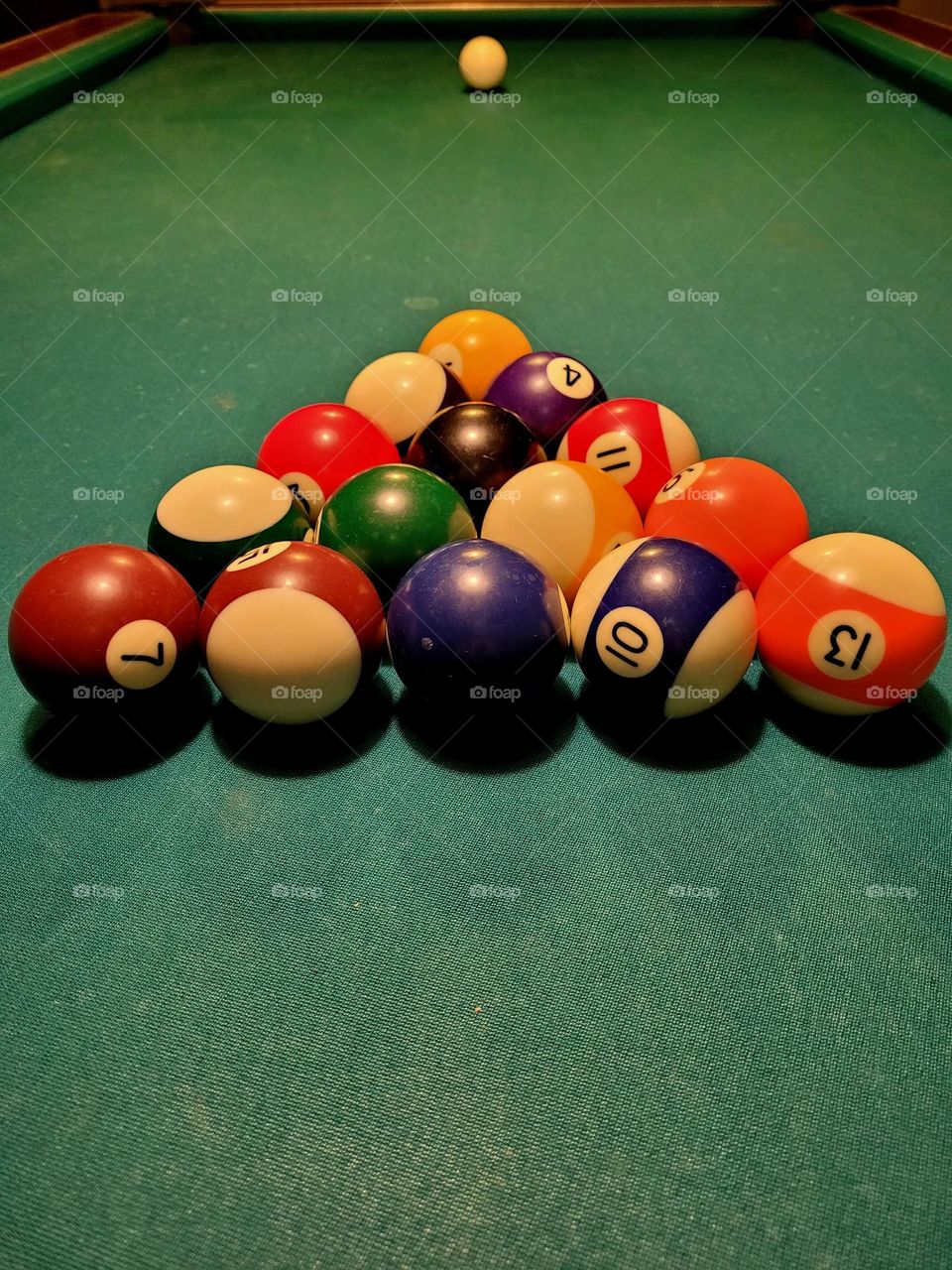 Billiards table with balls set to play in triangle shape.