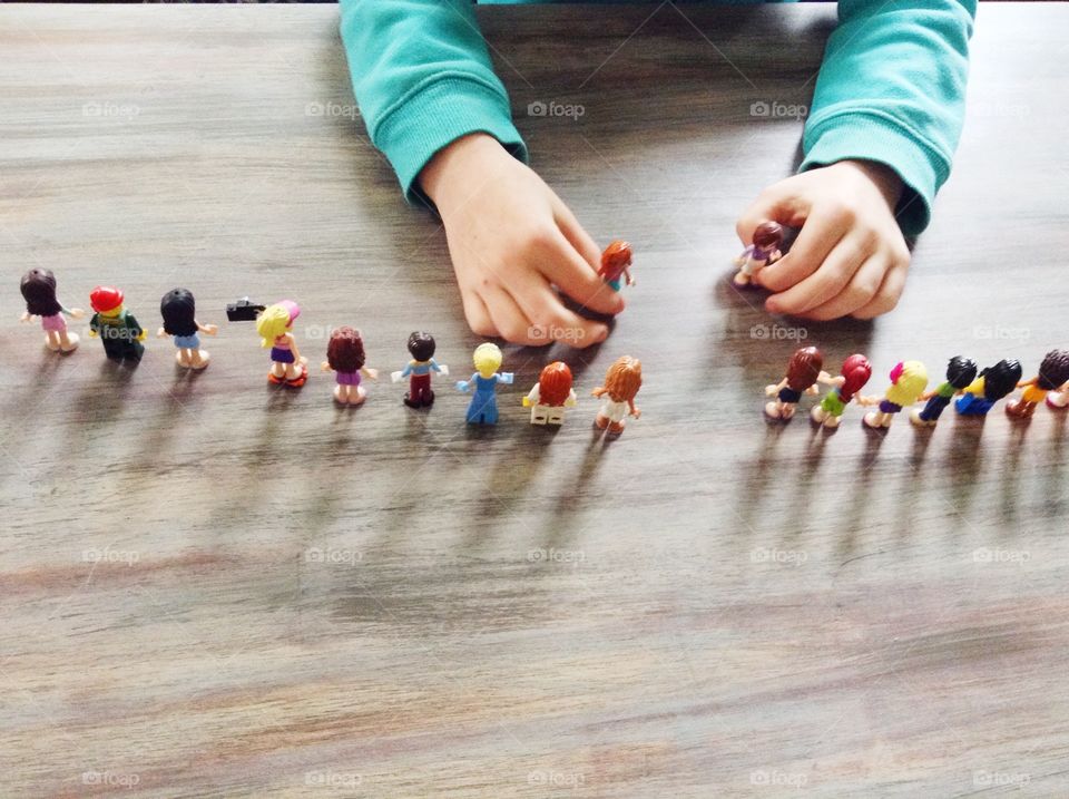 Girl playing with Lego Friends . Girl playing with mini Lego figures 