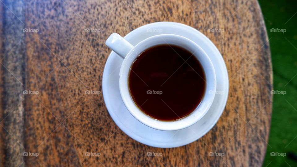 a cup of tea on a wooden table.