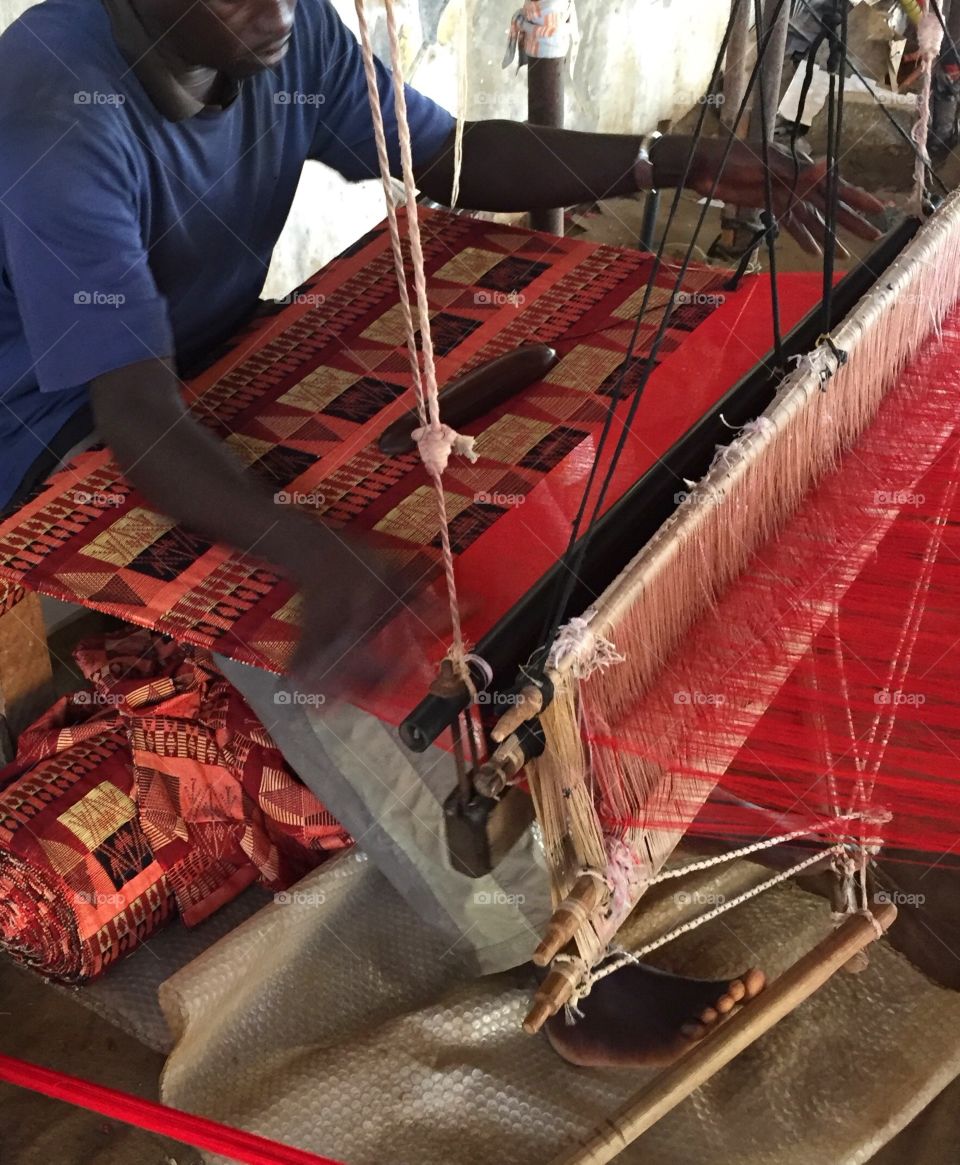 A weaver works at a loom