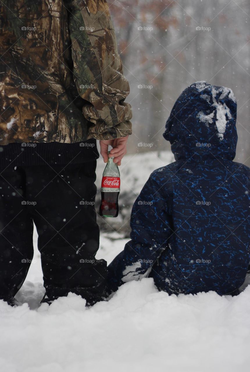 Father and son watching a fire on a snowy day