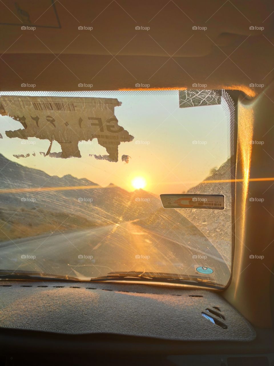 View of the sunset behind the window of the old Iranian car