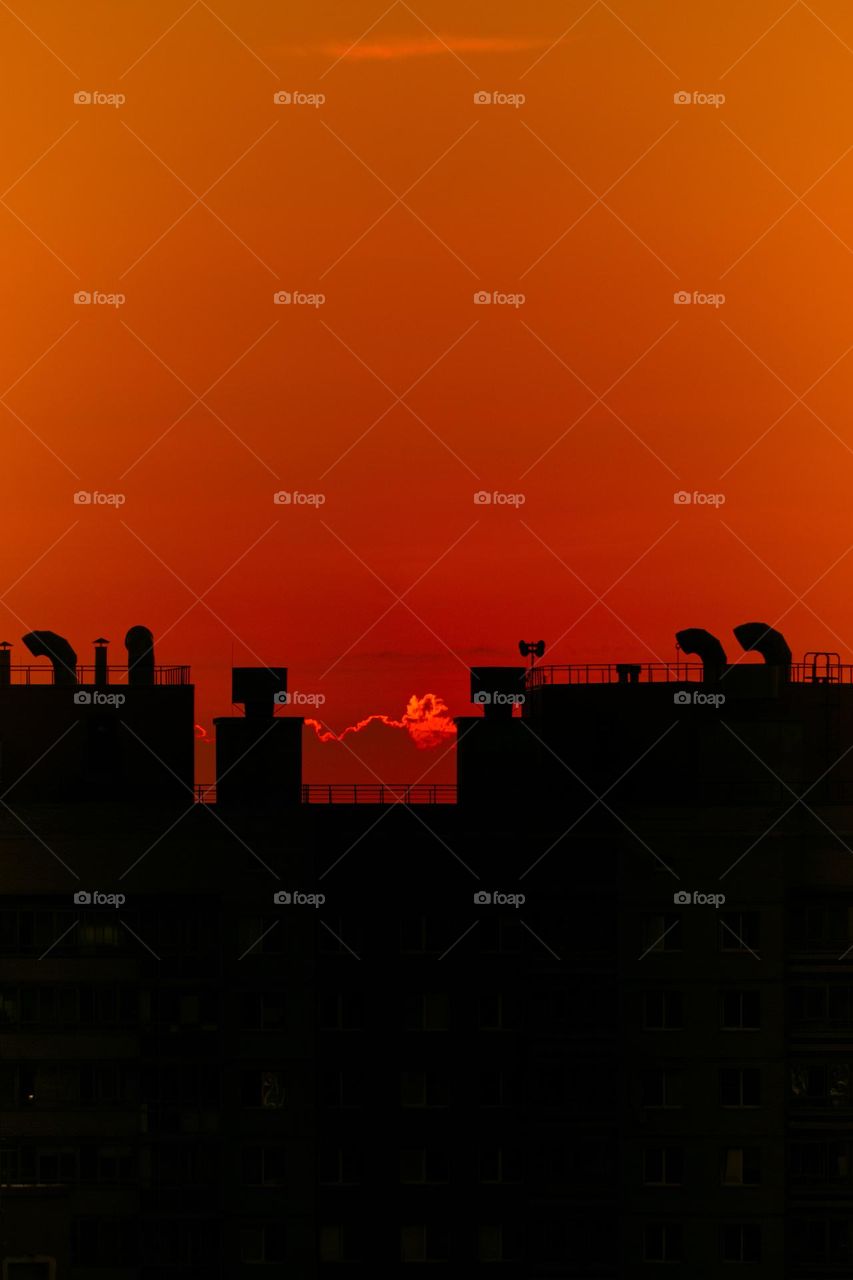 Red sky above the city rooftops