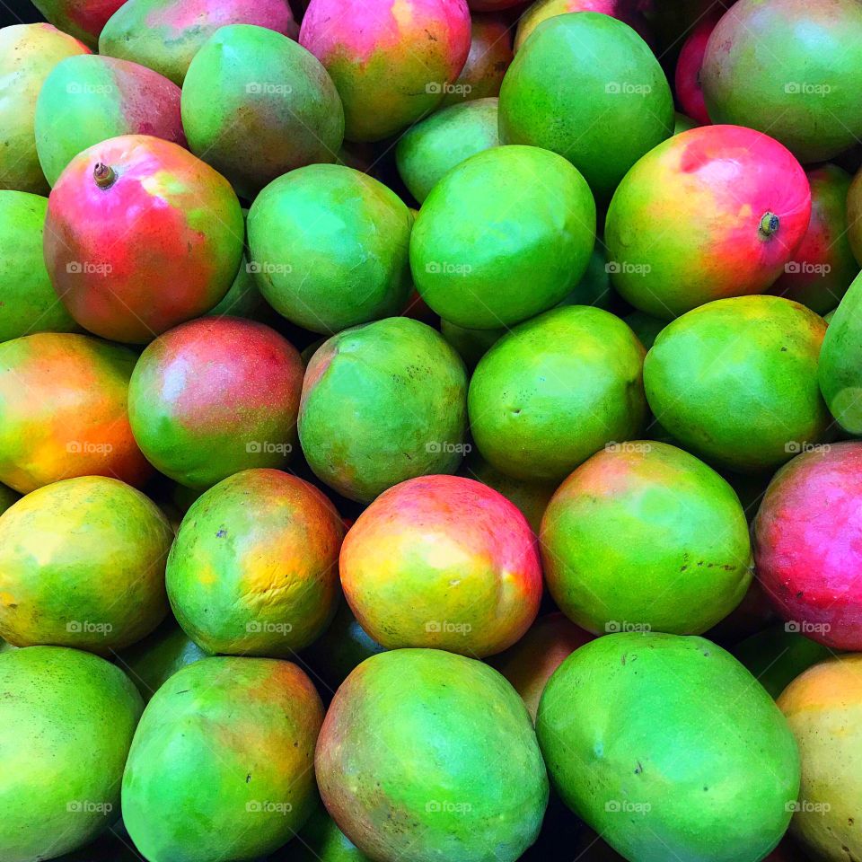 Colorful and delicious Mangoes at the market.