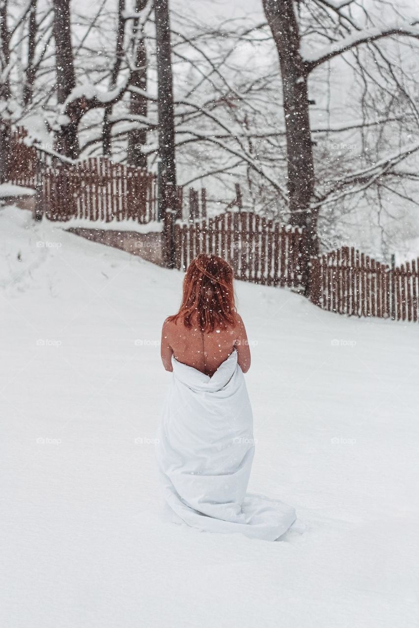 woman wearing a blanket in the snow