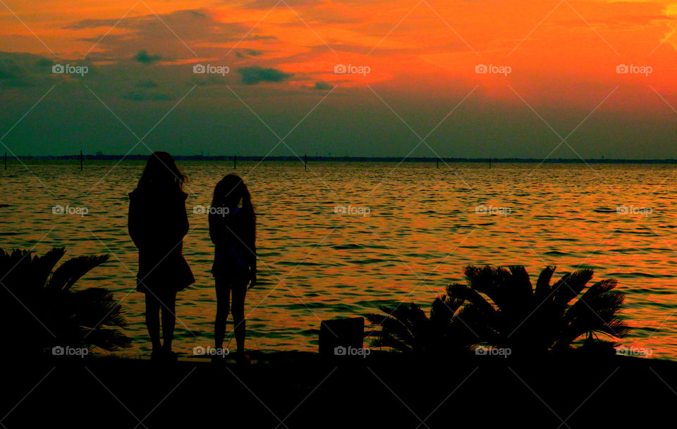 Sister Sunset. Two sisters are mesmerized by the captivating beauty of this sunset! Although they are young,their heart and soul is not
