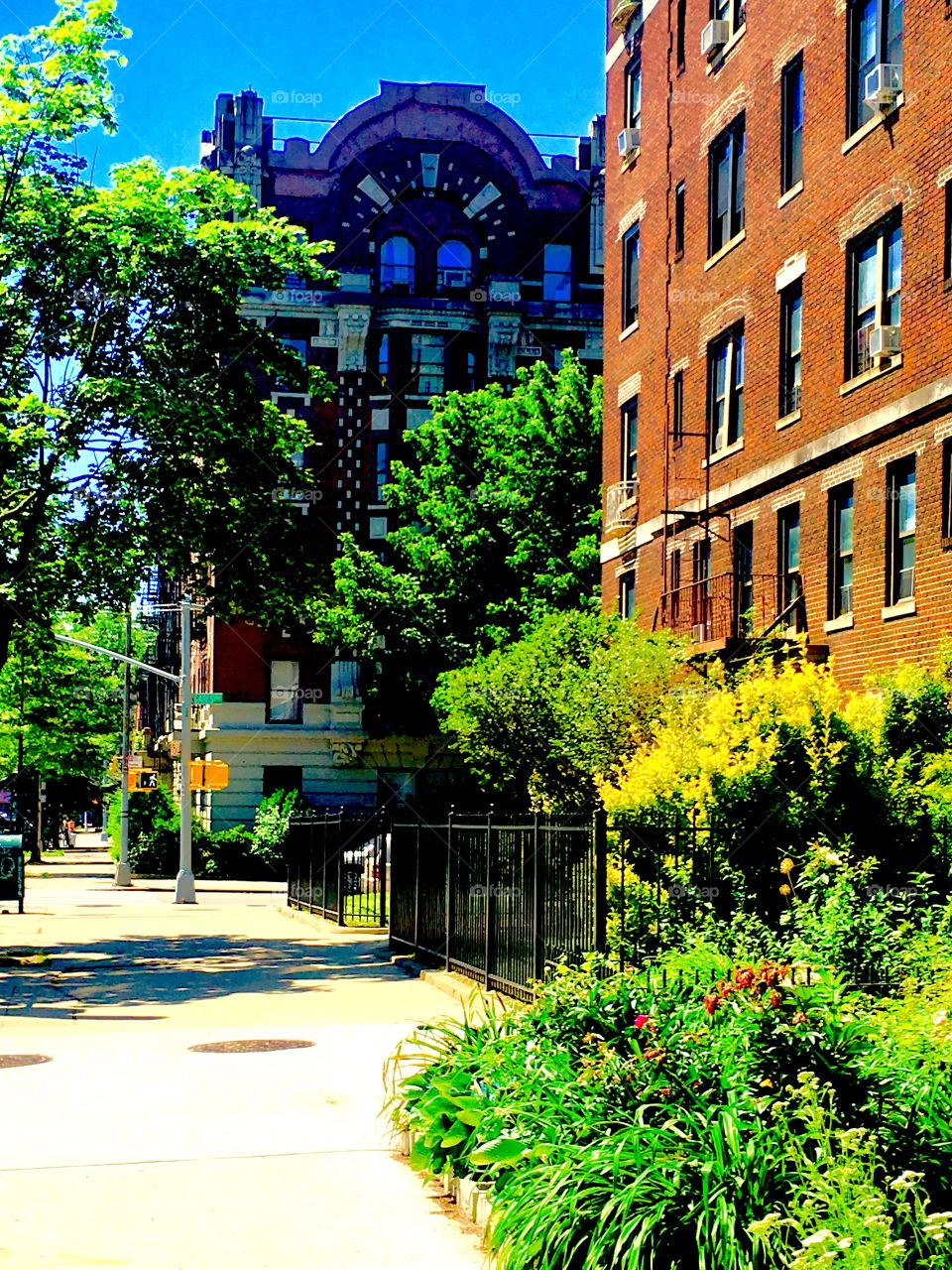 Fort Greene, Bklyn has brownstones with elements from bygone eras such as offset levels, half round shapes in the construction, arched windows, windows arranged in a demi circle, towers and more. 2019. Hypnotic Productions
