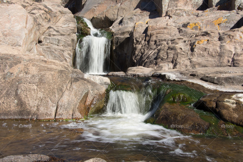 cascades on natural river betwen rocks