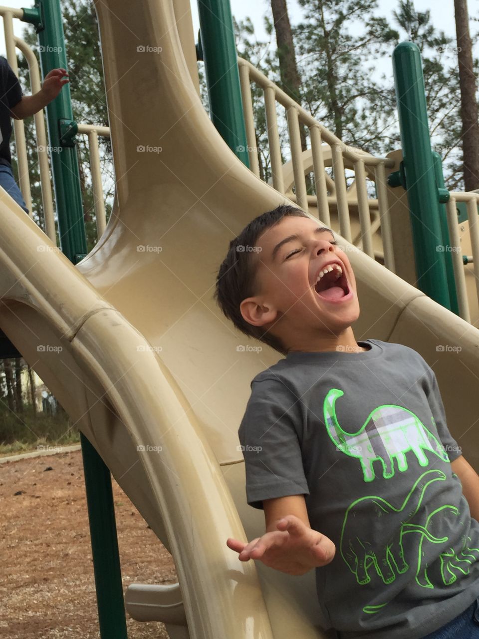Small child enjoying on slide