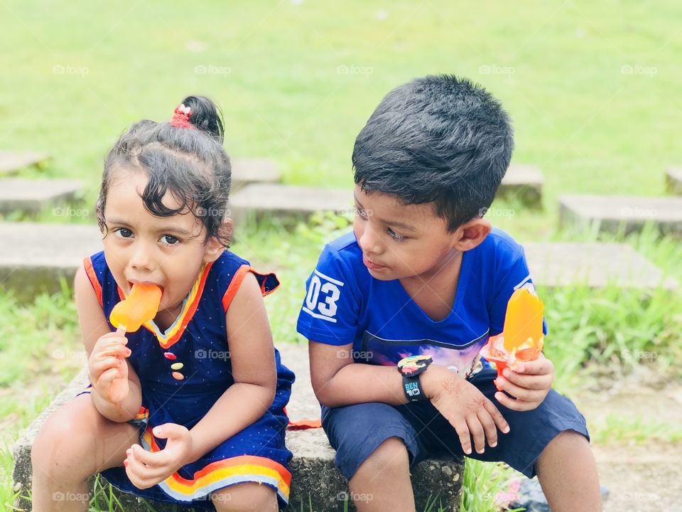 Children’s are playing & passing summer vacation..... eating icecream....