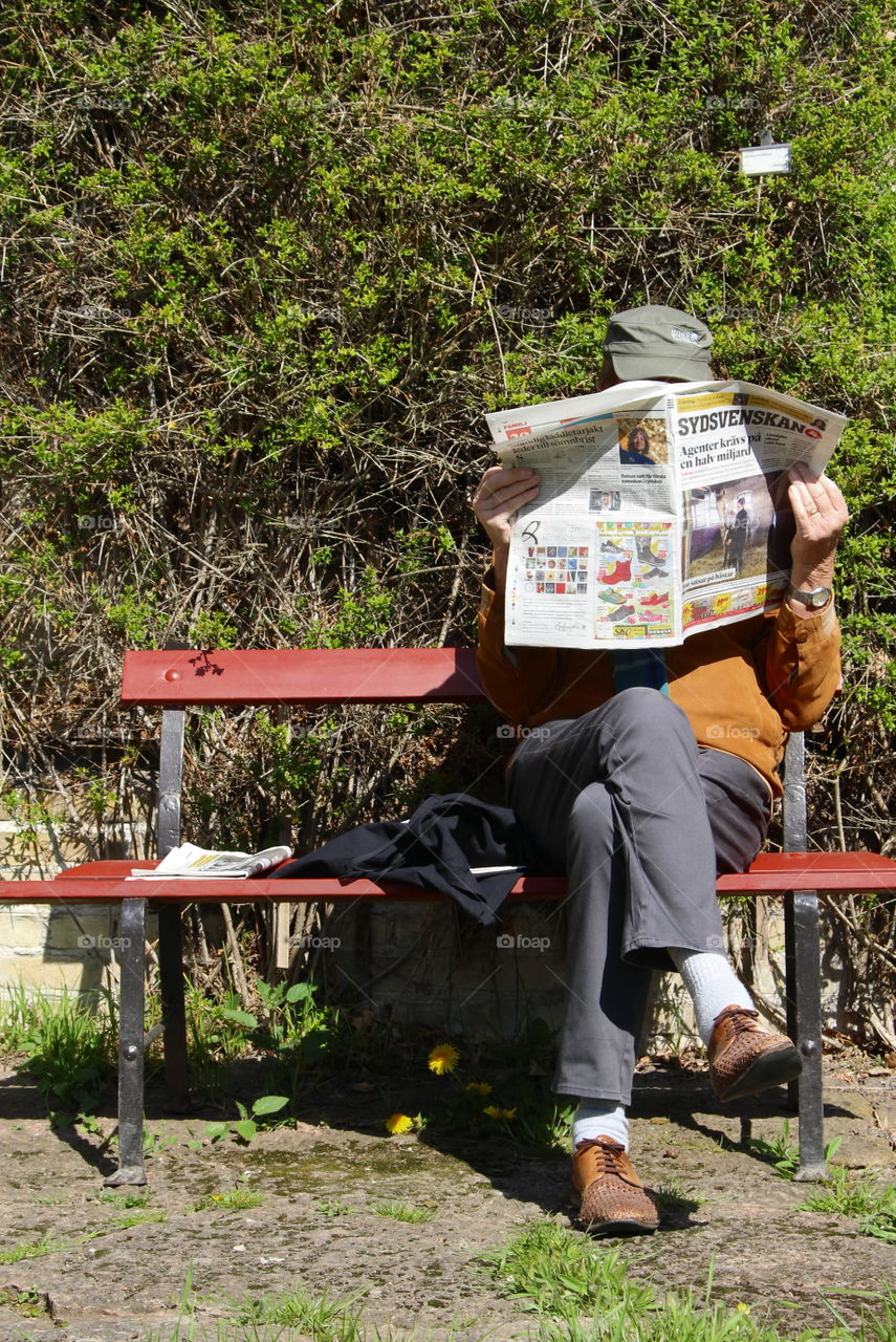 Old man reading newspaper