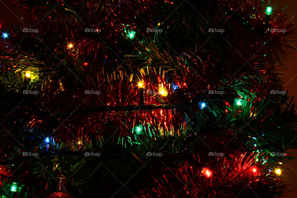 Macro shot of Christmas tree decorations and vivid lights