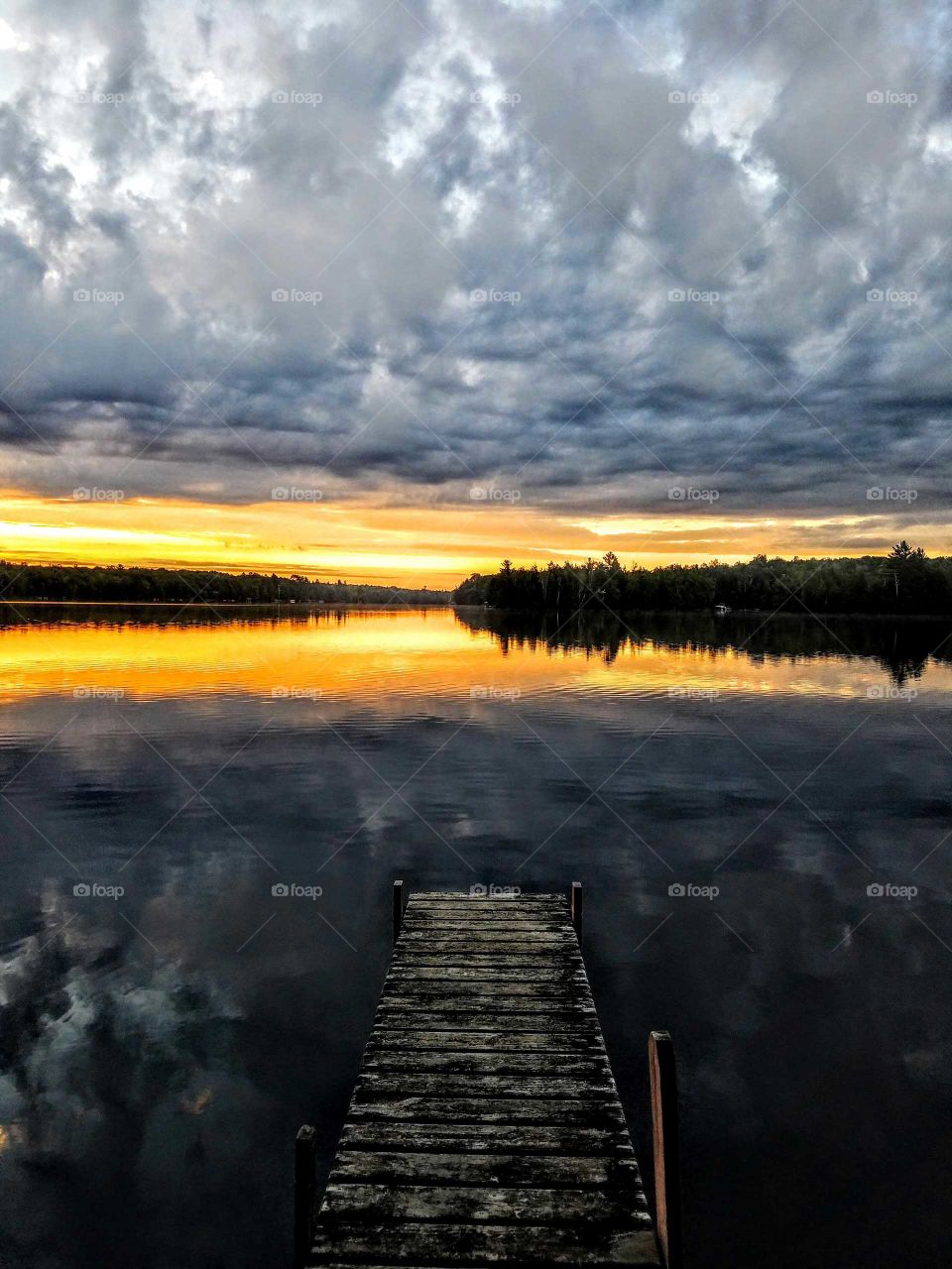 Scenic view of lake against cloudy sky