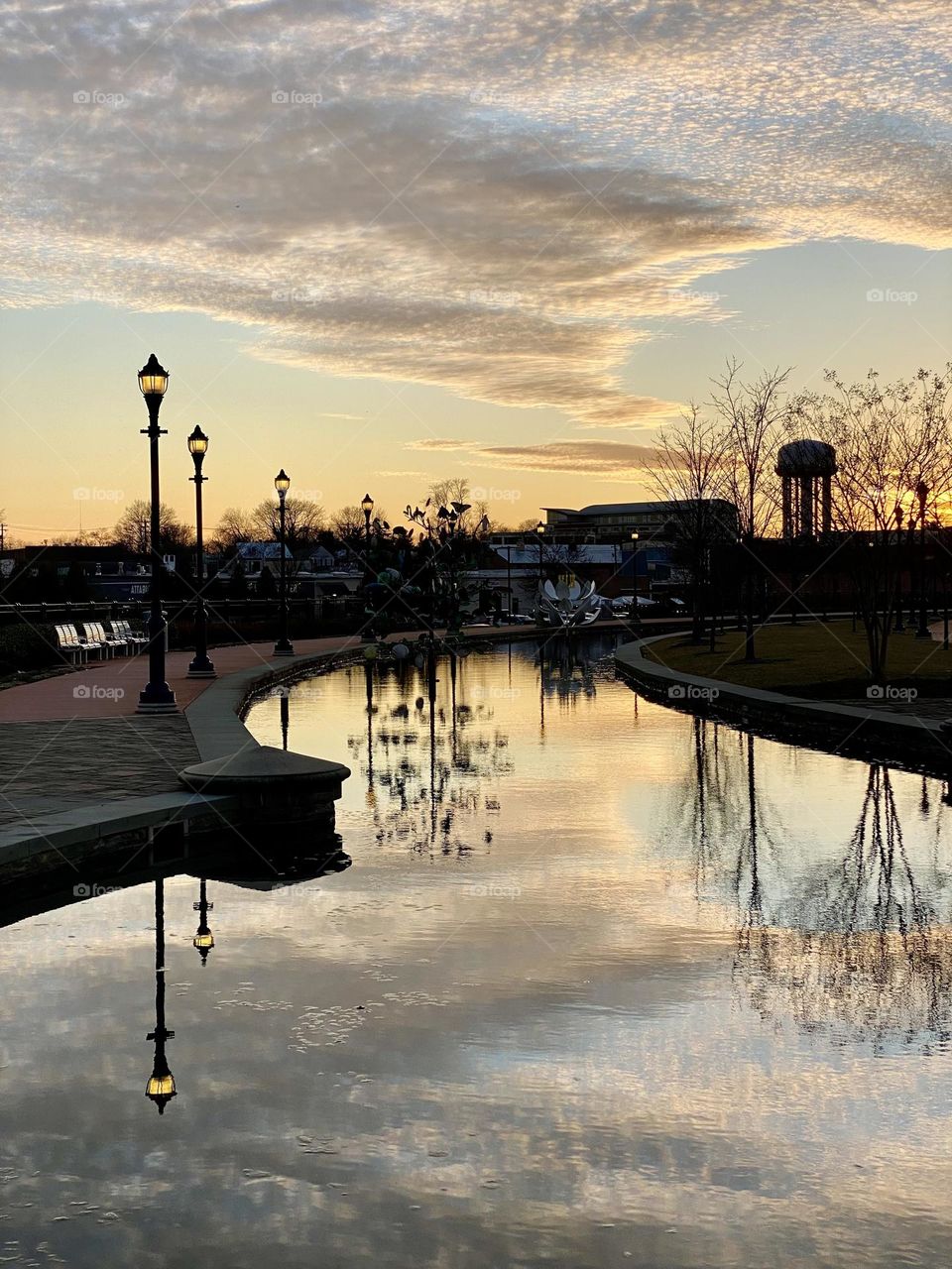 Reflections in the water at sunset on Carroll Creek in Frederick Maryland 