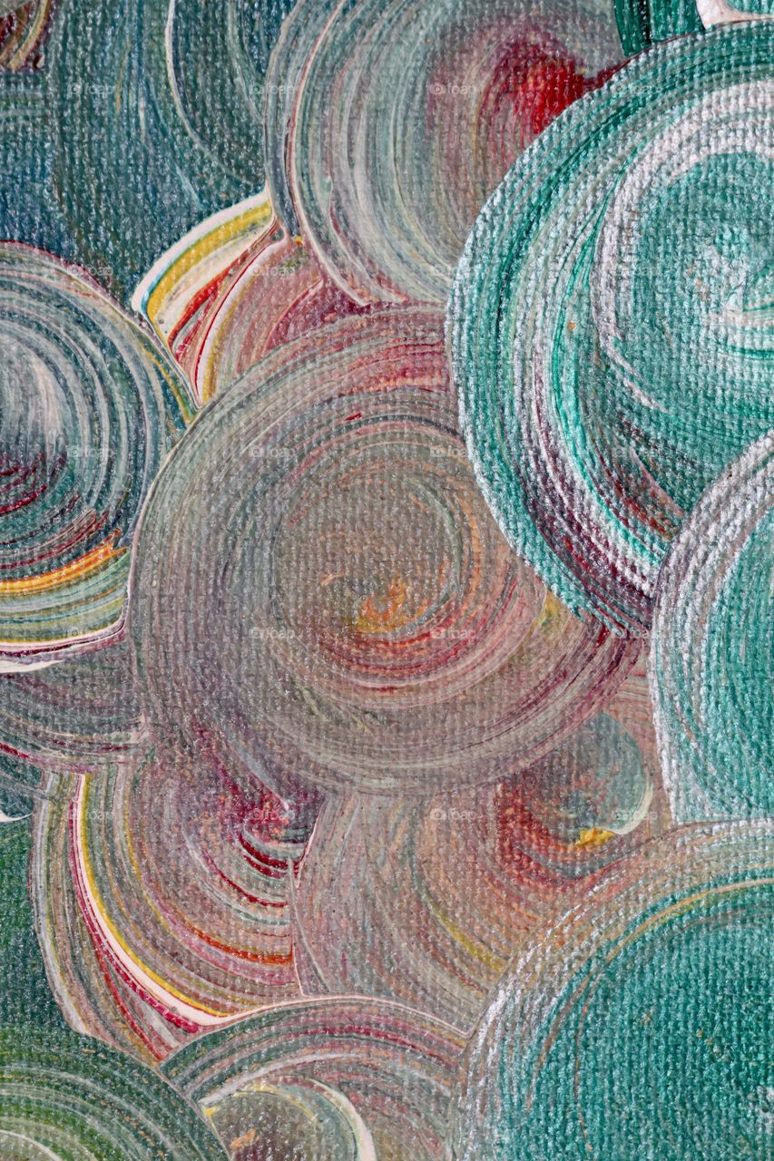 Closeup ocean theme paint colours swirled onto canvas textural brush strokes and pattern and repetition 