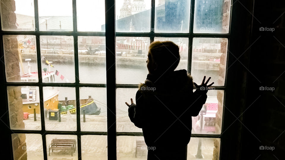 My son, Austin standing in the window of the famous marine museum, looking down at the boats in the stunning city of Liverpool, UK. 