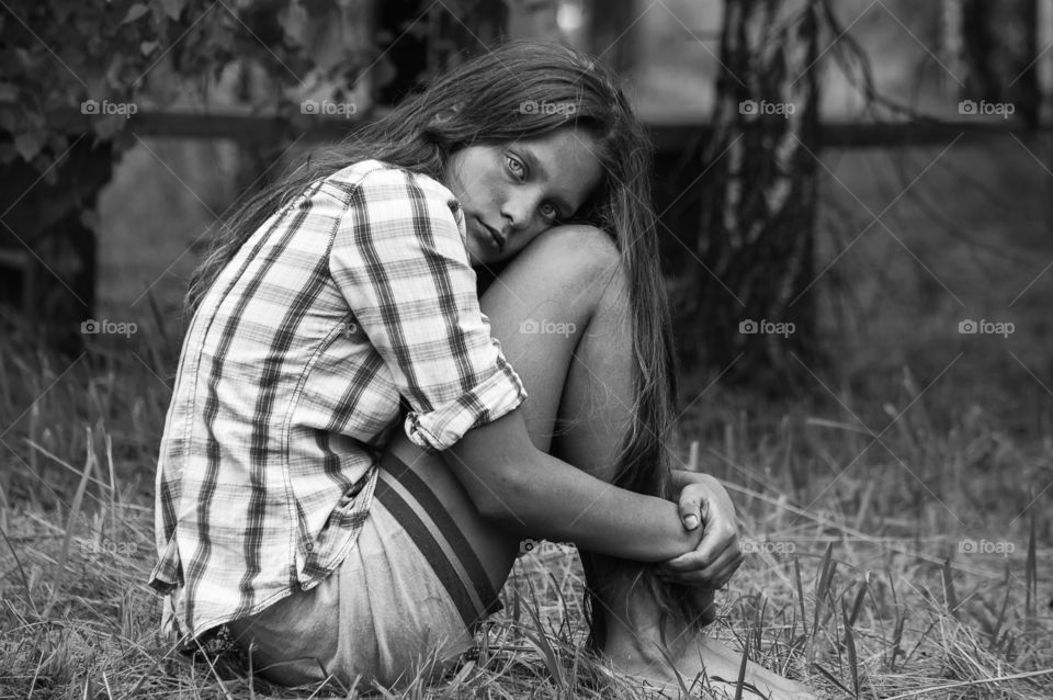 Girl is sitting on the grass