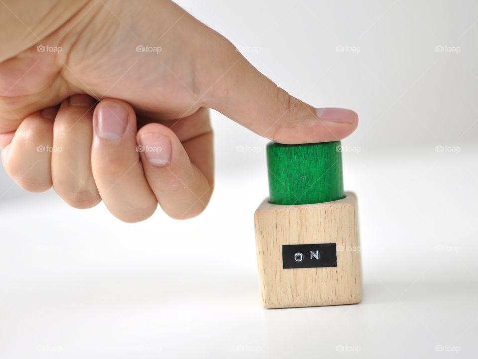 Thumb pressing green ON-button