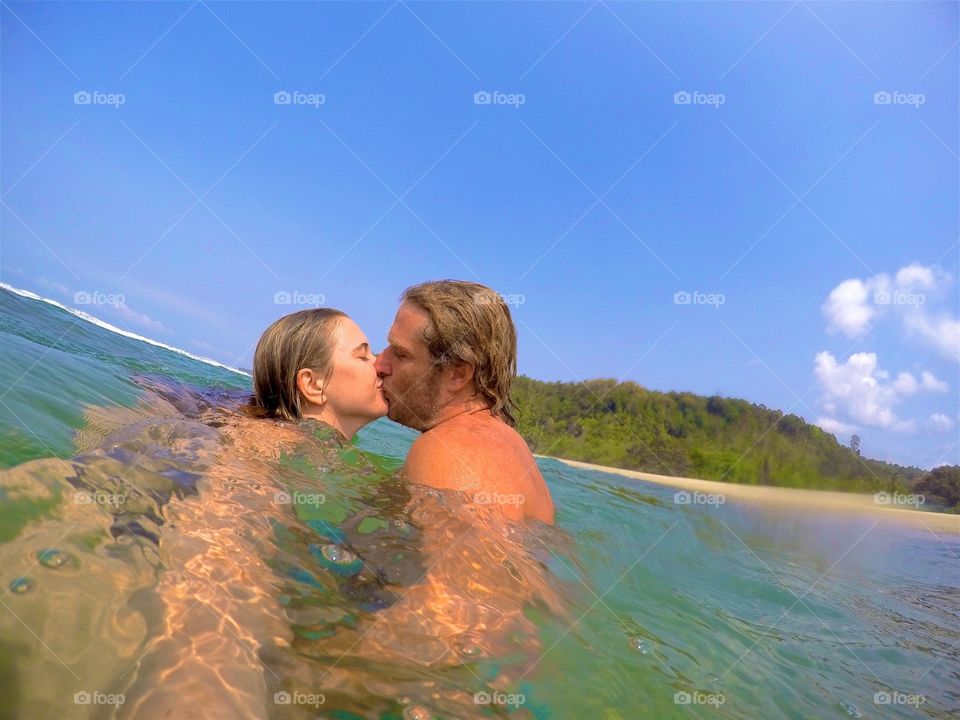 Couple kissing in ocean