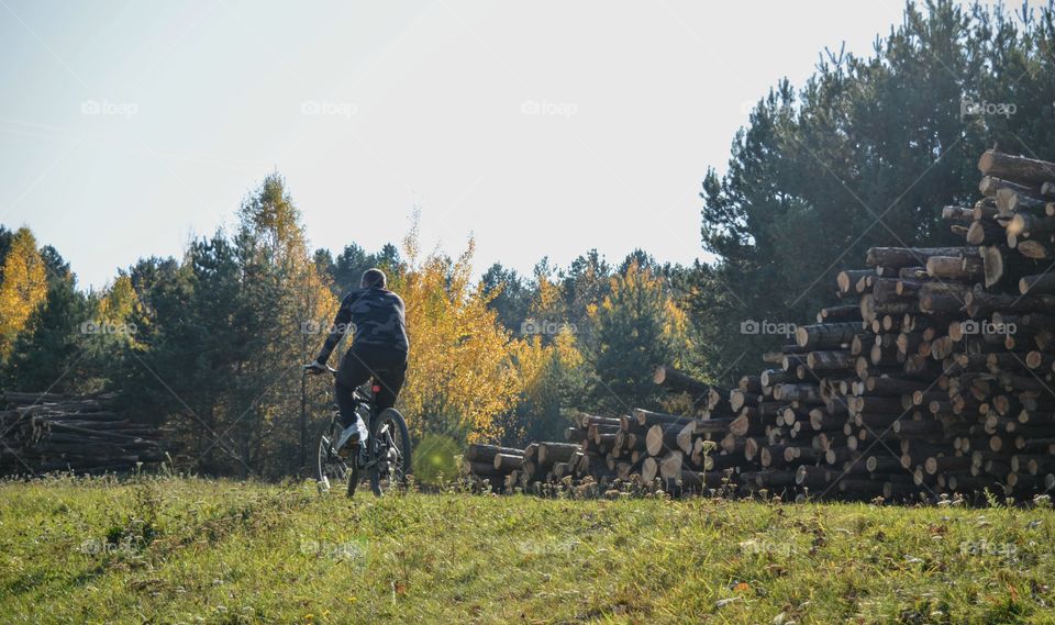 men riding on a bike autumn beautiful landscape