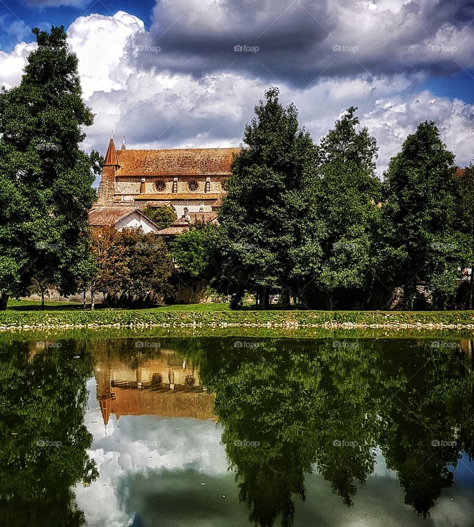 The church at Lauzun, France. A view from across the lake.