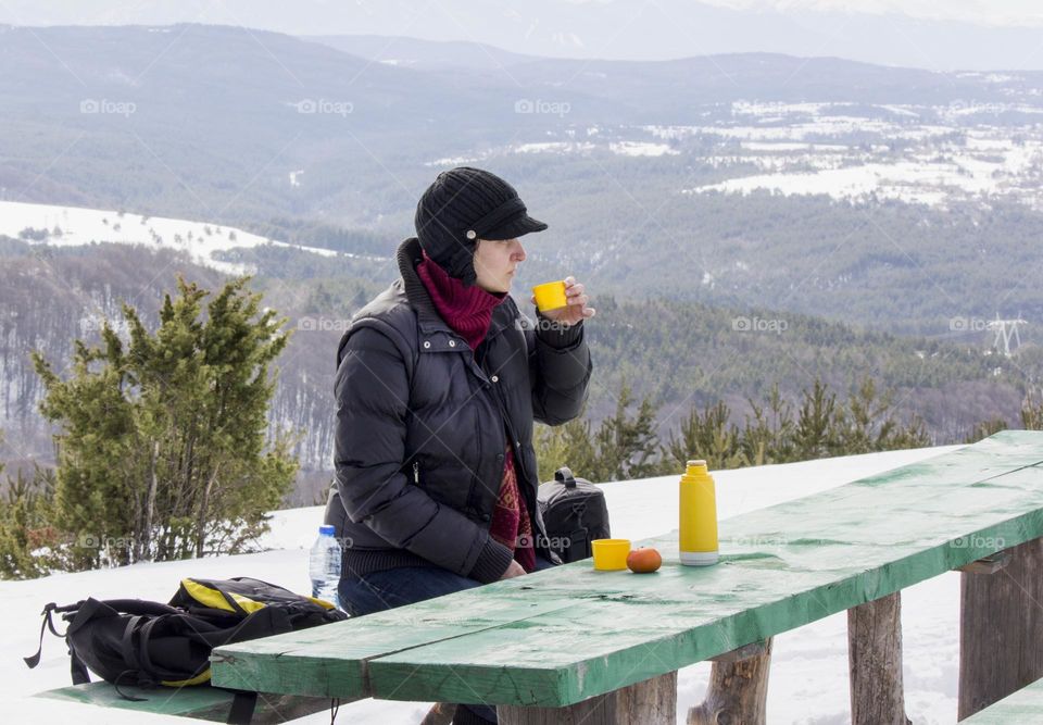 Winter portrait of a woman drinking tea