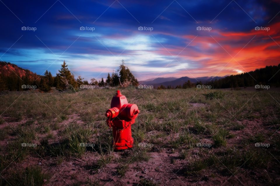 Water hydrant on hill at sunset