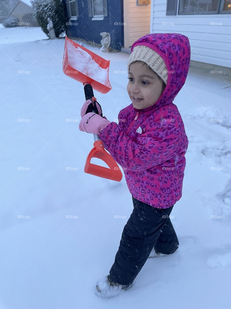 Little girl helps to shovel snow, helping mommy shovel the driveway, snowy days in the Midwest, snow days in Ohio 