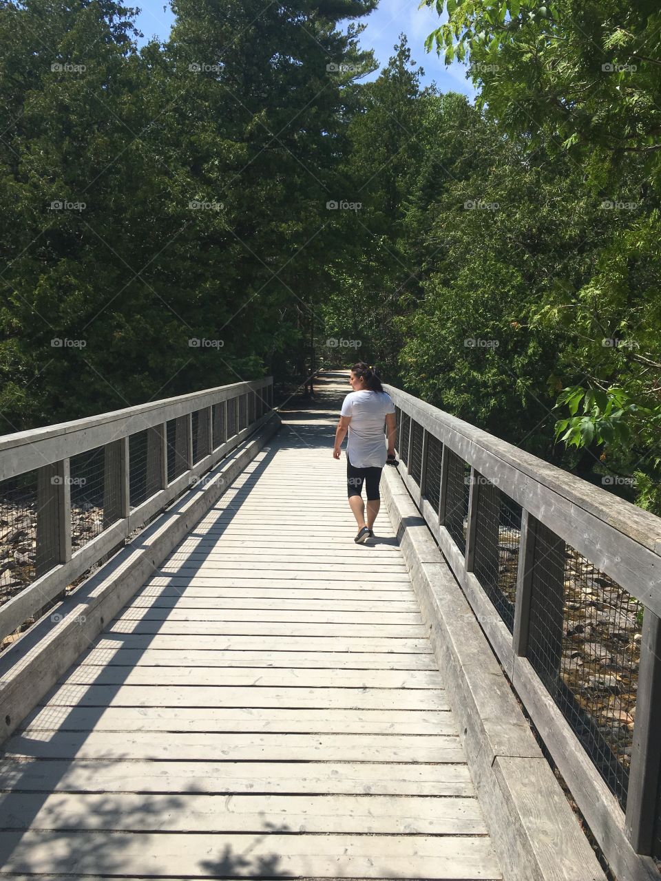Woman walking on bridge