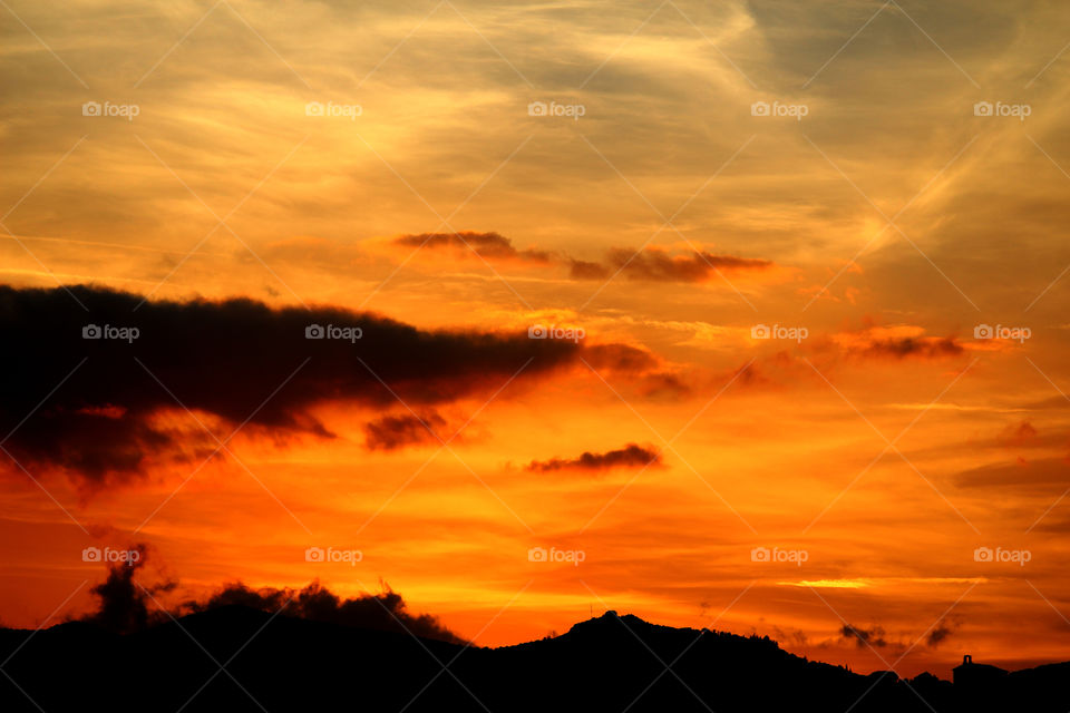 Dramatic sky over silhouetted mountain