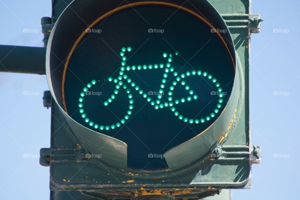 A traffic light on a bike path in Manhattan, New York City signals green "GO" for bicyclists.
