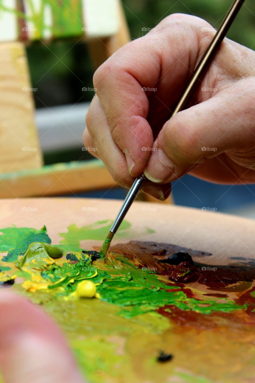 palette of greens and brown being mixed