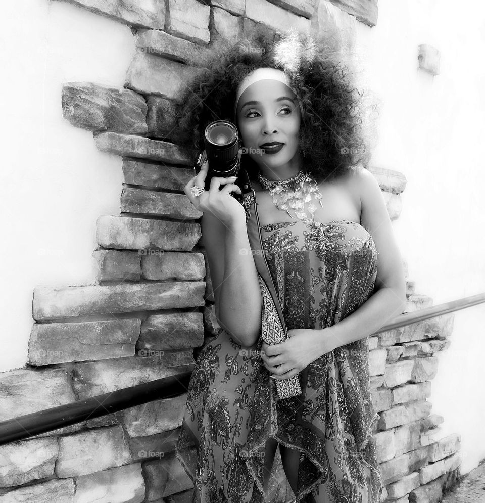 black and white of a fashion model holding a camera