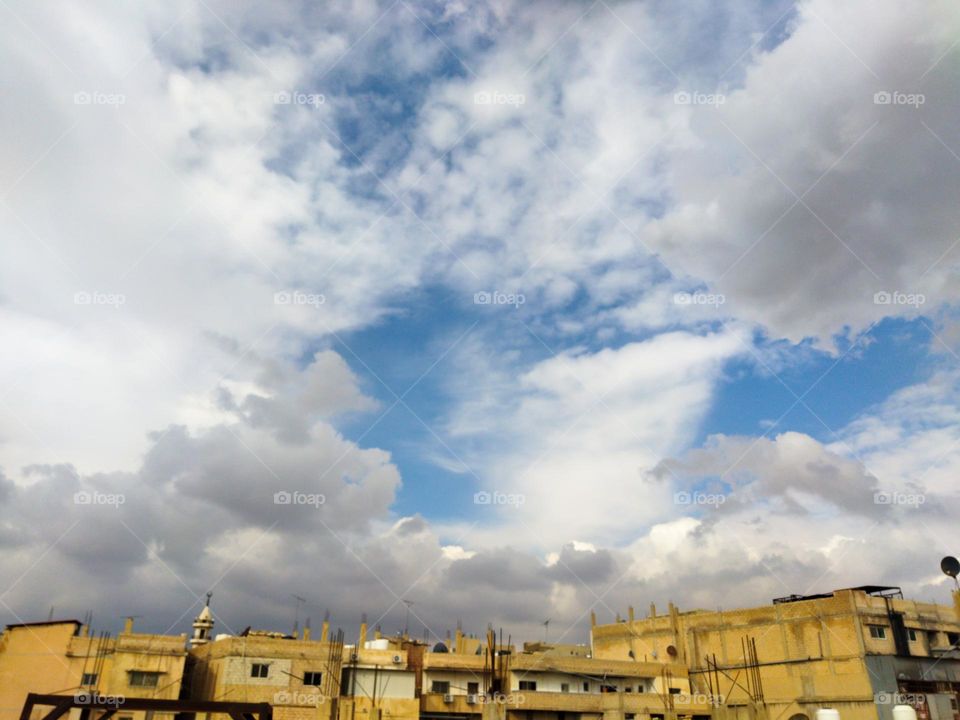 Old houses in a simple city with beautiful mixture clouds in the sky , minimalism