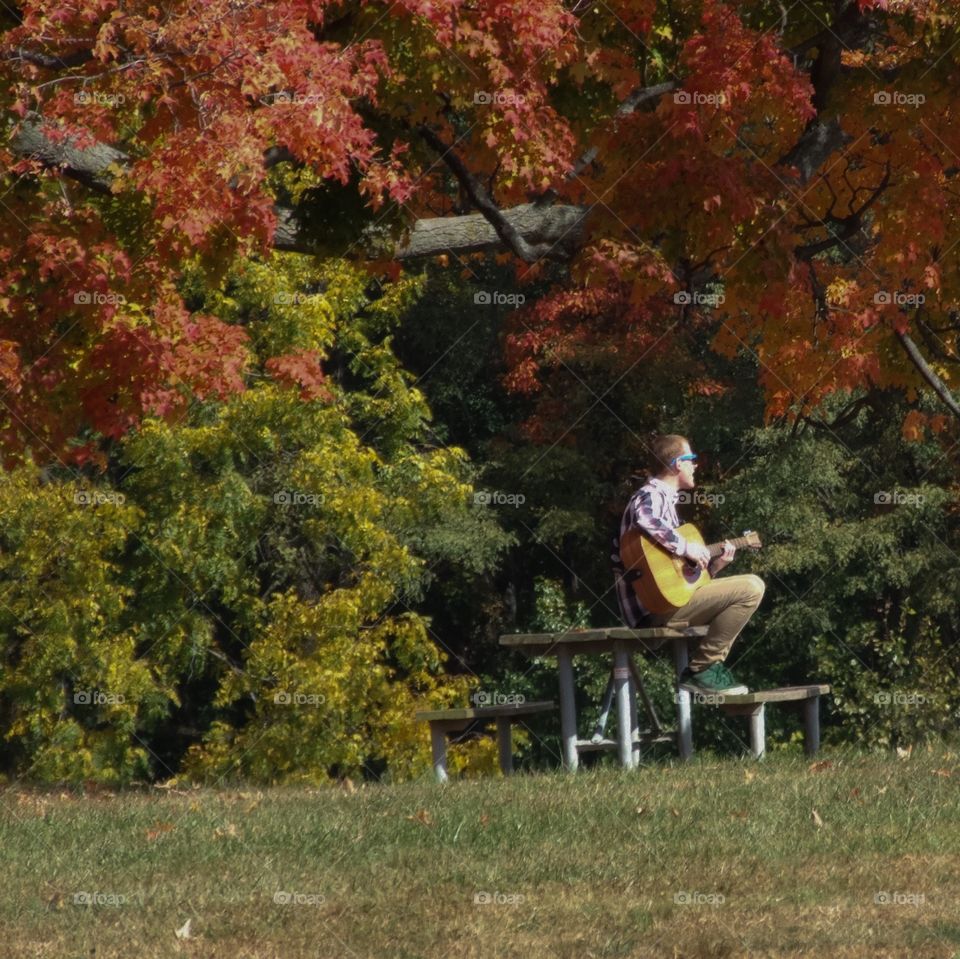 Man playing Guitar in park