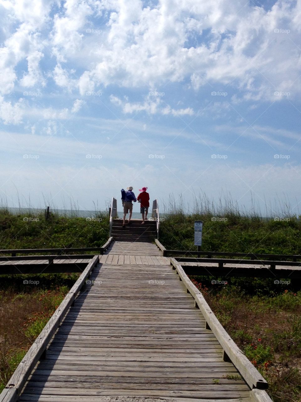 Two man standing on board walk