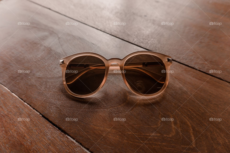 Brown glasses on a wooden table