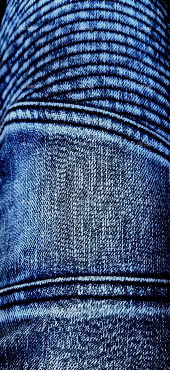 Closeup view to abstract space of empty blue natural clean denim jeans texture.