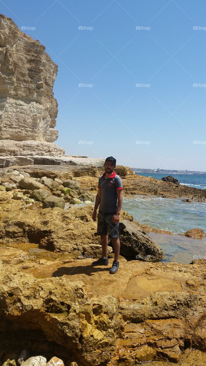 Young man standing on rock