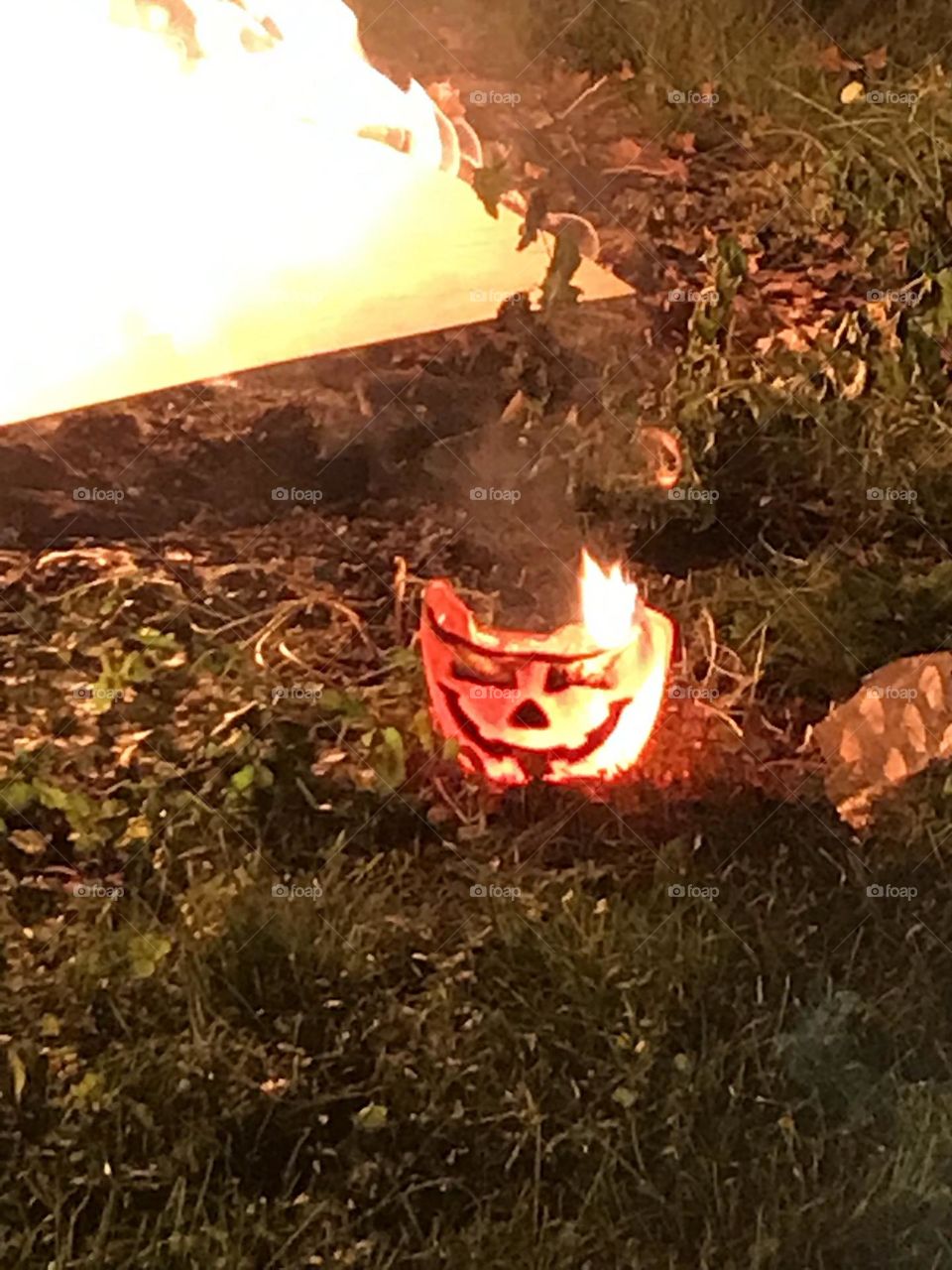 flaming Halloween pumpkin
flaming pumpkin
melting plastic bucket with pumpkin face
trick or treat on fire