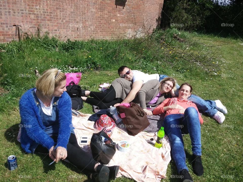 Family lying on grass in park