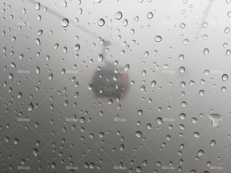 Cable car hanging among rain storm