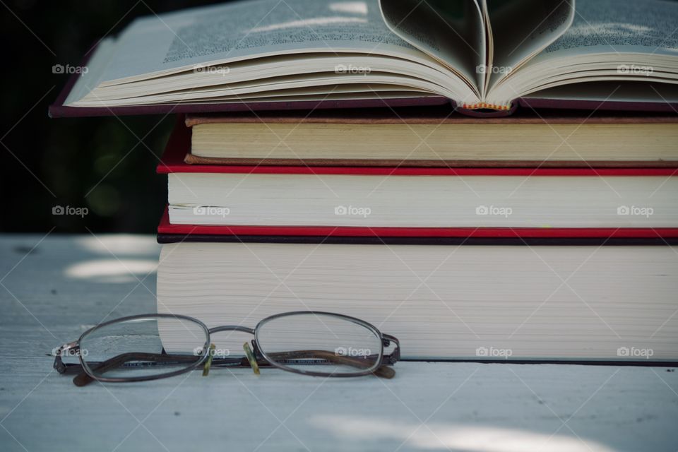 Reading glasses amongst books