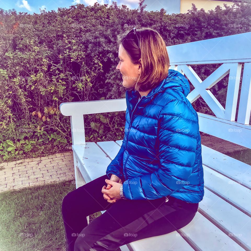 Lady in blue on bench 