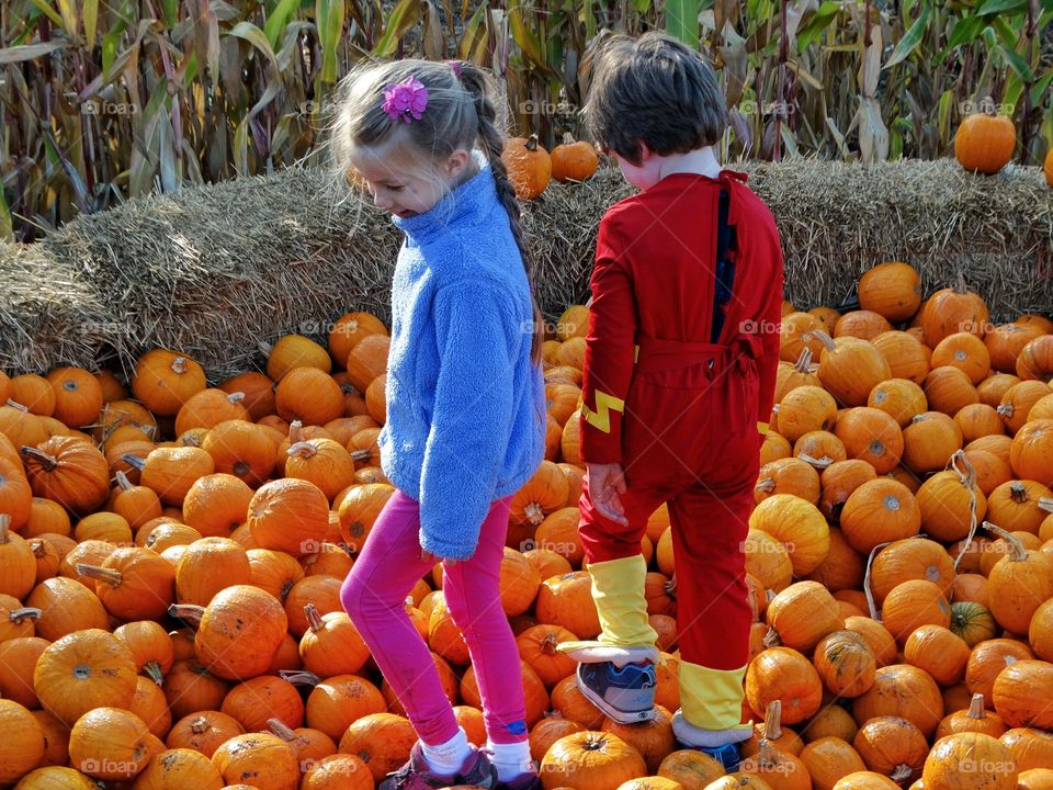 Boy And Girl In The Pumpkin Patch
